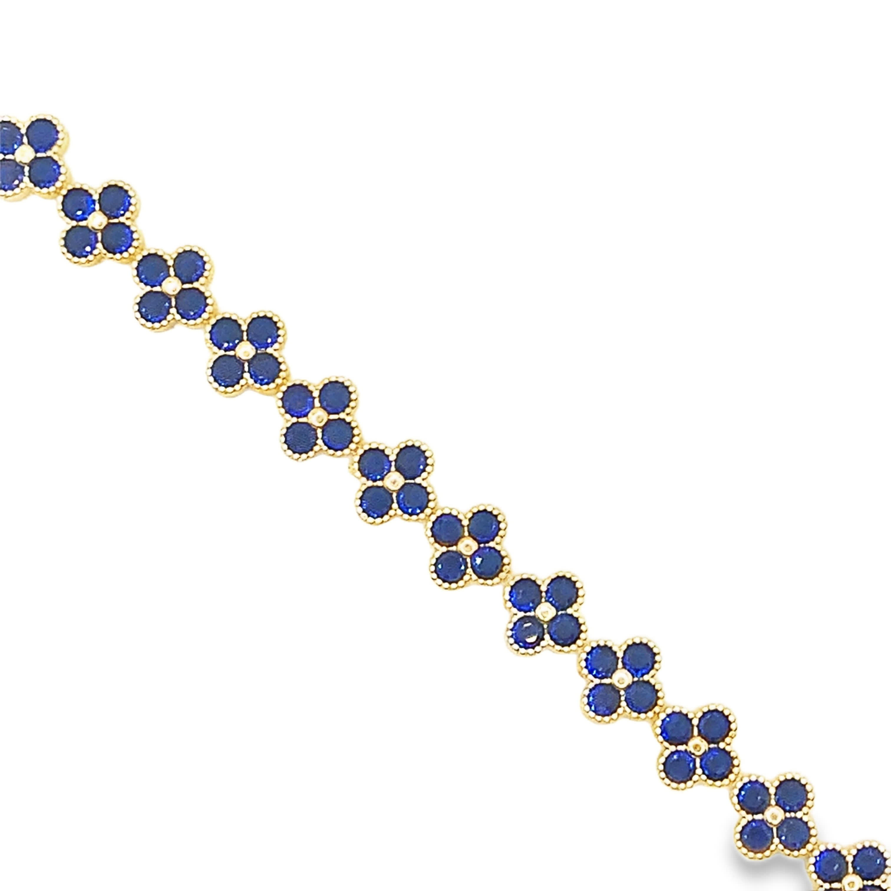 Bransoletka z żółtego złota z łańcuszkiem i akcentami z głęboko niebieskiego szafiru